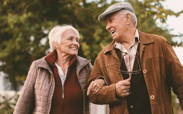 Older man and woman smiling at each other