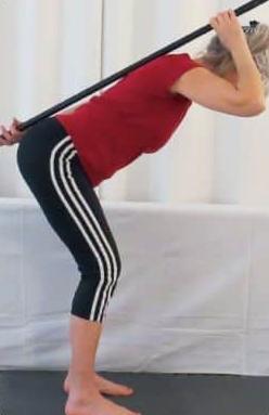 Woman training hip hinges
