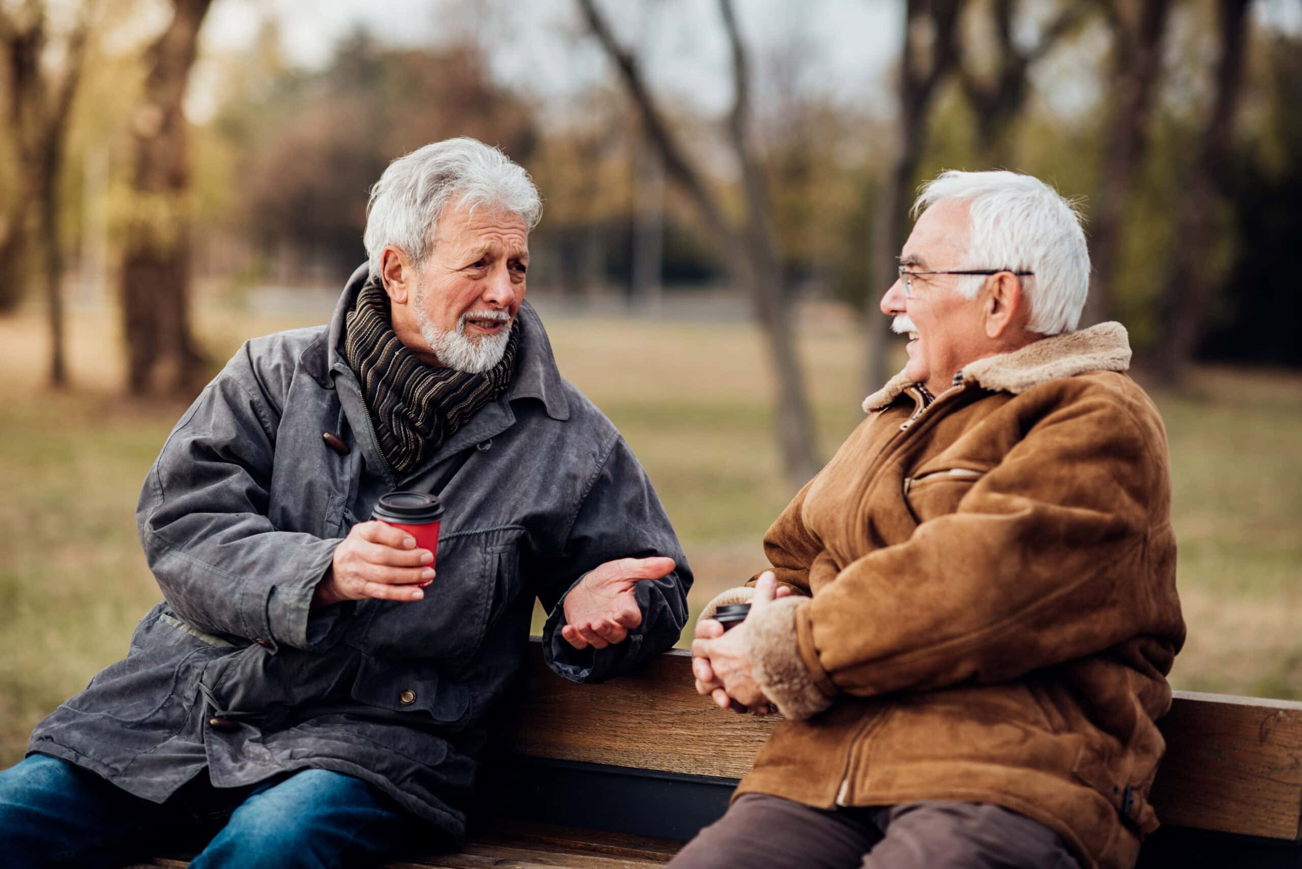 Two men speaking and sitting