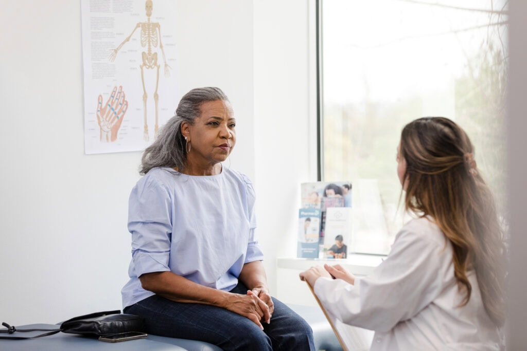 Healthcare professional speaking with patient